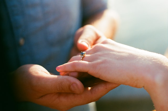 a woman showing off an alternative stone engagement ring